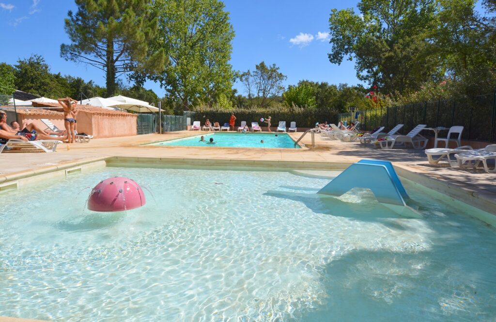 Piscine du Camping Santa Lucia à Porto-Vecchio, offrant une ambiance joyeuse et relaxante pour des vacances d'été mémorables, entourée de nature et de détente.